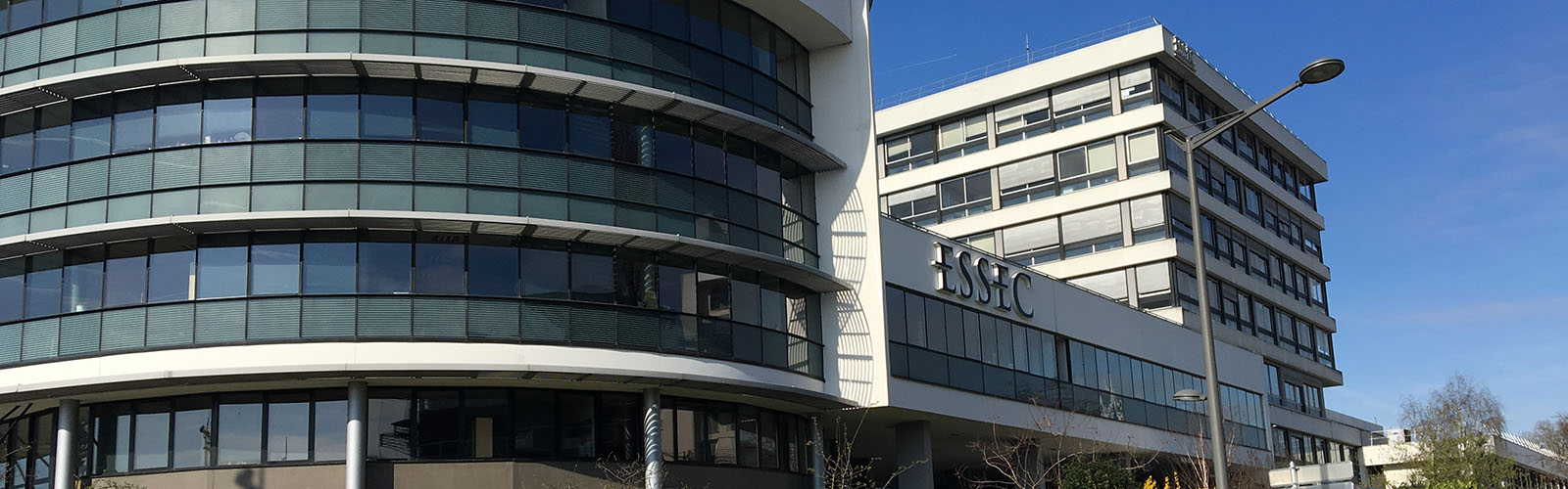 Exterior of a ESSEC building. The building has large, expansive windows and very modern architecture.